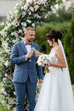 wedding ceremony of the newlyweds on the glade near the restaurant