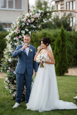 wedding ceremony of the newlyweds on the glade near the restaurant