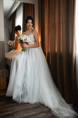 morning of the bride with the creation of the image of makeup and the creation of hairstyles