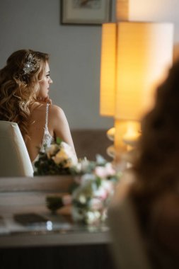 morning of the bride with the creation of the image of makeup and the creation of hairstyles