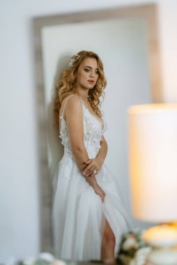 morning of the bride with the creation of the image of makeup and the creation of hairstyles