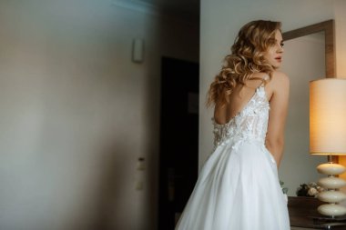 morning of the bride with the creation of the image of makeup and the creation of hairstyles