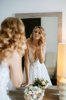 morning of the bride with the creation of the image of makeup and the creation of hairstyles