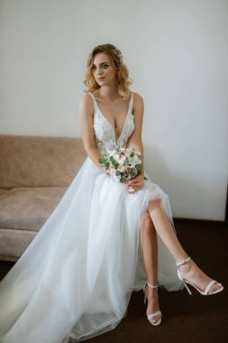 morning of the bride with the creation of the image of makeup and the creation of hairstyles