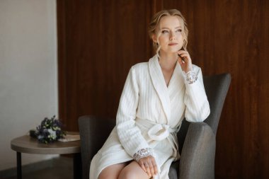 morning of the bride with the creation of the image of makeup and the creation of hairstyles