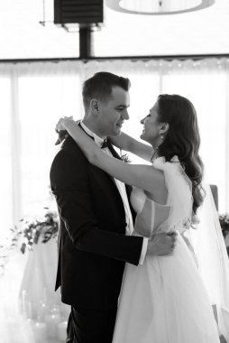 the first dance of the bride and groom inside a restaurant with heavy smoke