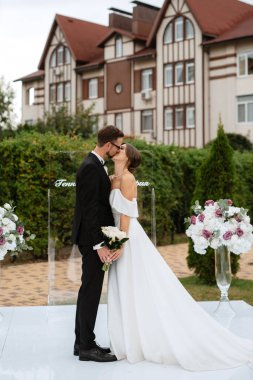 wedding ceremony of the newlyweds on the glade near the restaurant