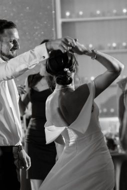 the first dance of the bride and groom inside a restaurant with heavy smoke