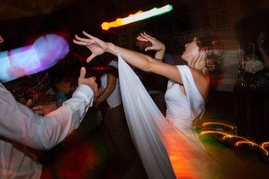 the first dance of the bride and groom inside a restaurant with heavy smoke
