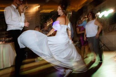 the first dance of the bride and groom inside a restaurant with heavy smoke
