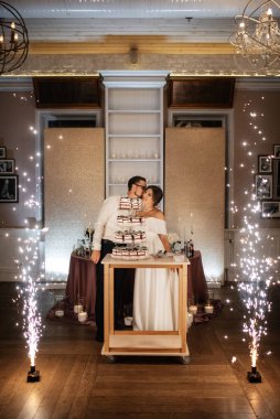 newlyweds happily cut, laugh and taste the wedding cake