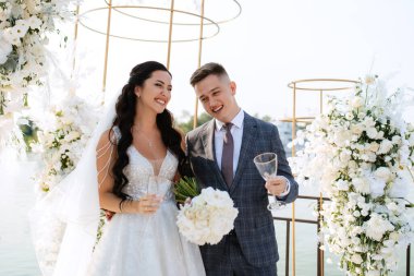 wedding ceremony of the newlyweds on the pier near the restaurant