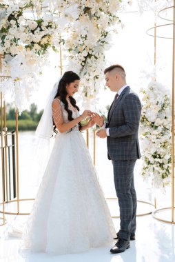 wedding ceremony of the newlyweds on the pier near the restaurant