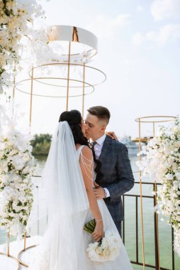 wedding ceremony of the newlyweds on the pier near the restaurant