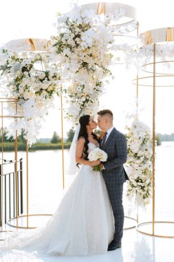 wedding ceremony of the newlyweds on the pier near the restaurant