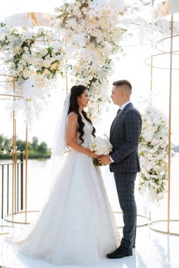 wedding ceremony of the newlyweds on the pier near the restaurant