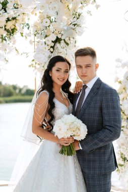 wedding ceremony of the newlyweds on the pier near the restaurant