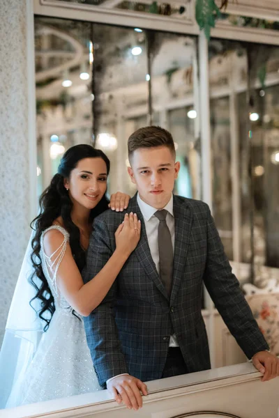 stock image bride and groom inside a cocktail bar in a bright atmosphere with a glass of drink