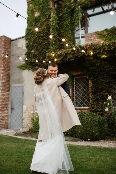 stock image the first wedding dance of the bride and groom inside the restaurant hall in sunset light