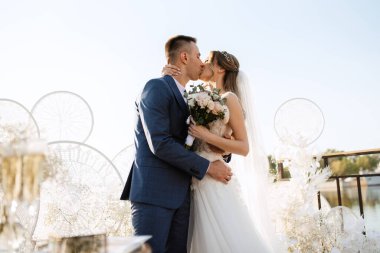 wedding ceremony of the newlyweds on the pier near the restaurant