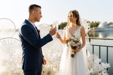 wedding ceremony of the newlyweds on the pier near the restaurant