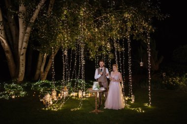 newlyweds happily cut, laugh and taste the wedding cake