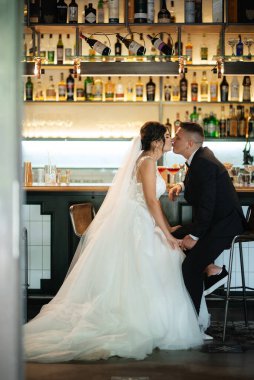 Gelin ve damat, canlı bir atmosferde bir kokteyl barında.