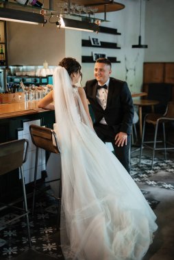 Gelin ve damat, canlı bir atmosferde bir kokteyl barında.