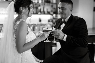 bride and groom inside a cocktail bar in a vibrant atmosphere