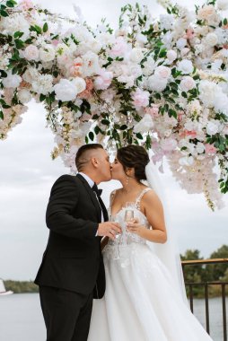 wedding ceremony of the newlyweds on the pier near the restaurant