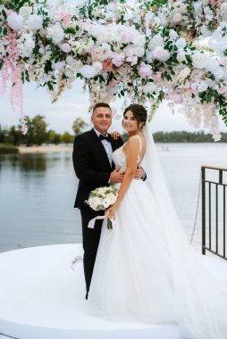 wedding ceremony of the newlyweds on the pier near the restaurant