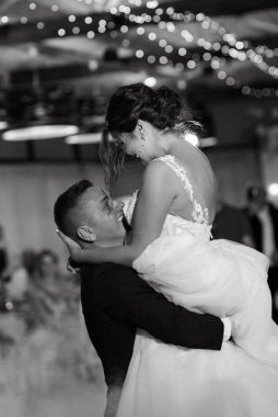 the first dance of the bride and groom inside a restaurant with heavy smoke