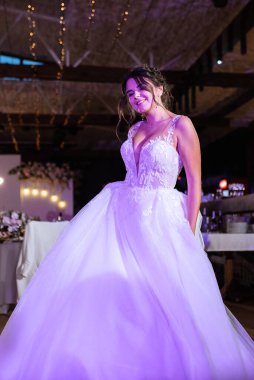 the first dance of the bride and groom inside a restaurant with heavy smoke