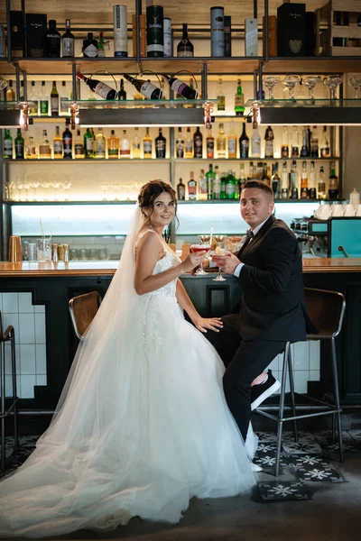 bride and groom inside a cocktail bar in a vibrant atmosphere