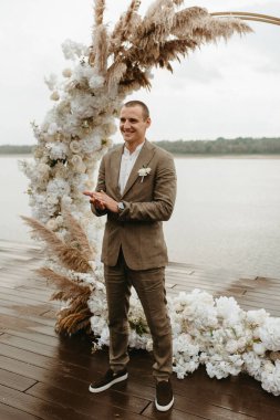 wedding ceremony of the newlyweds on the pier near the restaurant