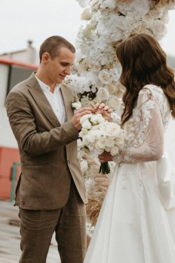 wedding ceremony of the newlyweds on the pier near the restaurant