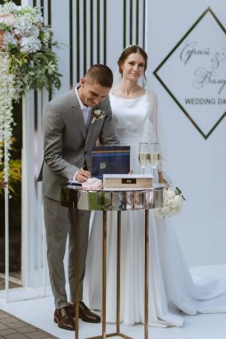 wedding ceremony of the newlyweds on the glade near the restaurant