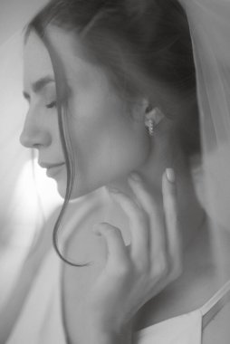 preparations for the bride with the dressing of the wedding dress in the studio