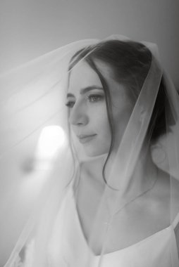 preparations for the bride with the dressing of the wedding dress in the studio