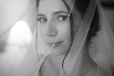 preparations for the bride with the dressing of the wedding dress in the studio