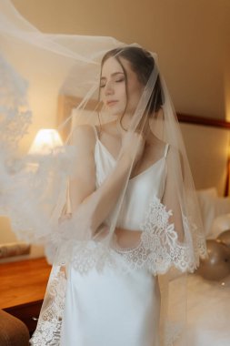preparations for the bride with the dressing of the wedding dress in the studio