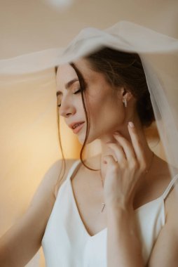 preparations for the bride with the dressing of the wedding dress in the studio