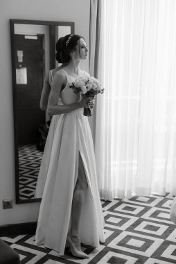 preparations for the bride with the dressing of the wedding dress in the studio