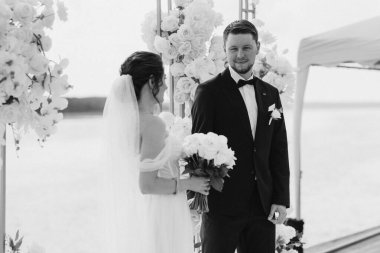 wedding ceremony of the newlyweds on the pier near the restaurant