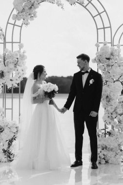 wedding ceremony of the newlyweds on the pier near the restaurant