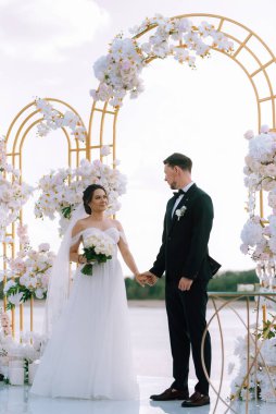 wedding ceremony of the newlyweds on the pier near the restaurant