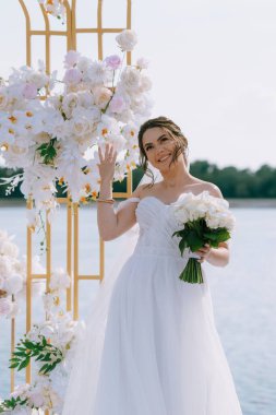 wedding ceremony of the newlyweds on the pier near the restaurant