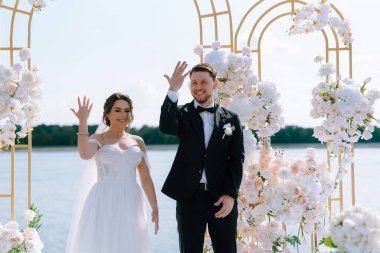wedding ceremony of the newlyweds on the pier near the restaurant