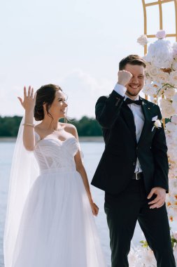 wedding ceremony of the newlyweds on the pier near the restaurant