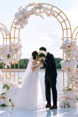 wedding ceremony of the newlyweds on the pier near the restaurant